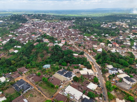 Aerial view of ohafia showing a winding road amidst a dense settlement of homes and verdant hills under a cloudy sky ohafia Abia Nigeria. Aerial view of ohafia showing a winding road amidst a dense settlement of homes and verdant hills under a cloudy sky ohafia Abia Nigeria.