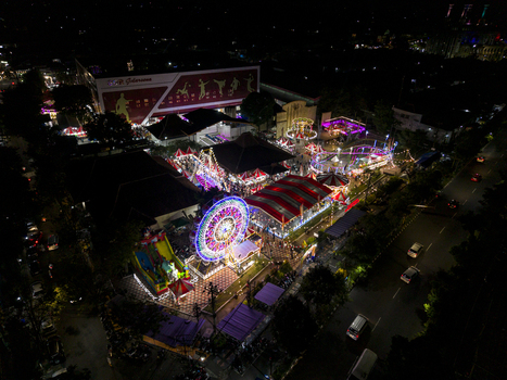 Aerial view of GOR Gelarsena Klaten Night Market with an illuminated ferris wheel colorful carnival rides and crowds at night Kecamatan Klaten Utara Jawa Tengah Indonesia. Aerial view of GOR Gelarsena Klaten Night Market with an illuminated ferris wheel colorful carnival rides and crowds at night Kecamatan Klaten Utara Jawa Tengah Indonesia.