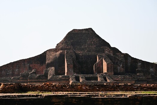 View of Sompur Mahavihara an ancient Buddhist monastery with weathered red brick walls and tiered structure under a clear sky in Naogaon District Rajshahi Division Bangladesh. View of Sompur Mahavihara an ancient Buddhist monastery with weathered red brick walls and tiered structure under a clear sky in Naogaon District Rajshahi Division Bangladesh.