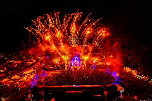 Herzogenaurach Germany 27 July 2025 Aerial view of the Open Beatz Festival featuring massive fireworks exploding over a large crowd and an illuminated ferris wheel at night. Herzogenaurach Germany 27 July 2025 Aerial view of the Open Beatz Festival featuring massive fireworks exploding over a large crowd and an illuminated ferris wheel at night.