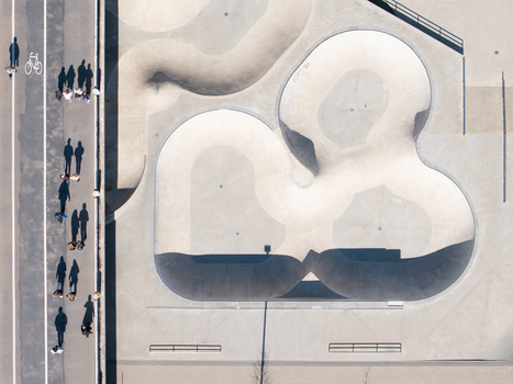 Aerial view of Chiune Sugihara Sakura Park featuring concrete skate bowls and a nearby pedestrian path with people walking and cycling in Vilnius Vilniaus apskritis Lithuania. Aerial view of Chiune Sugihara Sakura Park featuring concrete skate bowls and a nearby pedestrian path with people walking and cycling in Vilnius Vilniaus apskritis Lithuania.