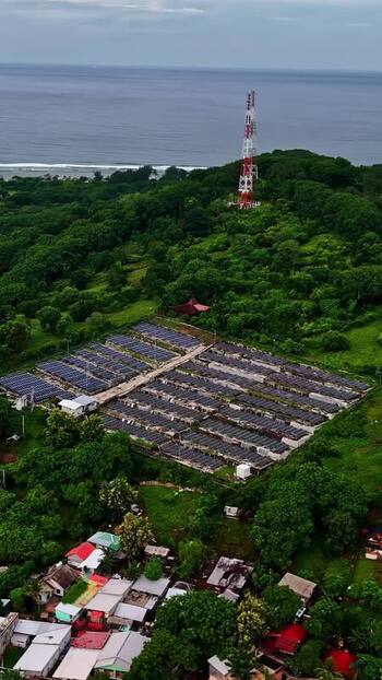 Aerial view of solar farm and communication tower in Bali Indonesia.