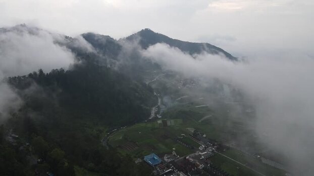Aerial view of misty mountains and green hills in Indonesia. Aerial view of misty mountains and green hills in Indonesia.