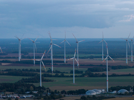 Aerial view of Sieversdorf Windpark with numerous wind turbines standing in agricultural fields under a cloudy sky in Jacobsdorf Brandenburg Germany. Aerial view of Sieversdorf Windpark with numerous wind turbines standing in agricultural fields under a cloudy sky in Jacobsdorf Brandenburg Germany.