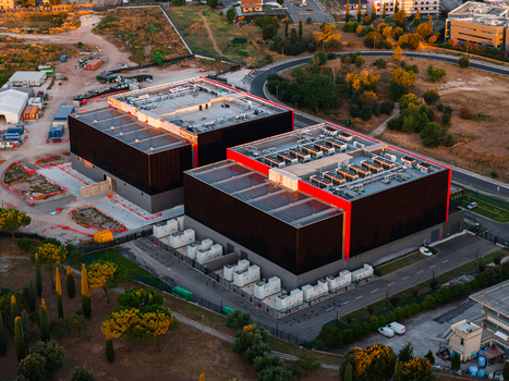 Aerial view of a modern datacenter facility with large server buildings cooling units and surrounding infrastructure in Settecamini Lazio Italy.