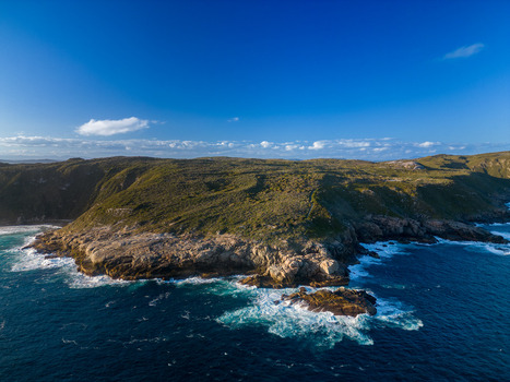Aerial view of the rugged coastline and rocky cliffs of Torndirrup National Park with crashing waves and deep blue ocean waters in Torndirrup Western Australia Australia. Aerial view of the rugged coastline and rocky cliffs of Torndirrup National Park with crashing waves and deep blue ocean waters in Torndirrup Western Australia Australia.