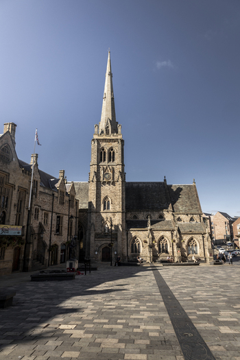 Durham England United Kingdom 13 July 2026 View of St Nicholas Church in the historic market square with stone architecture arched windows and a tall spire under a clear blue sky. Durham England United Kingdom 13 July 2026 View of St Nicholas Church in the historic market square with stone architecture arched windows and a tall spire under a clear blue sky.