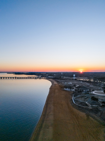 Aerial view of Sandy Point State Park with its sandy shoreline and the Chesapeake Bay Bridge in the distance during a golden sunset Annapolis Maryland United States. Aerial view of Sandy Point State Park with its sandy shoreline and the Chesapeake Bay Bridge in the distance during a golden sunset Annapolis Maryland United States.