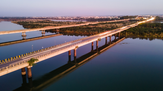 Aerial view of the Jhelum River bridges at dusk with the city skyline in the background and lush green riverbanks Jhelum Punjab Pakistan. Aerial view of the Jhelum River bridges at dusk with the city skyline in the background and lush green riverbanks Jhelum Punjab Pakistan.