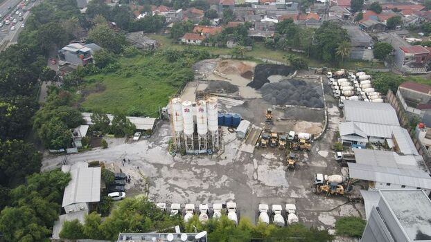 Serpong Sub District Banten Indonesia 11 May 2022 Aerial view of a concrete batching plant with tall silos gravel piles and cement mixer trucks in an industrial yard. Serpong Sub District Banten Indonesia 11 May 2022 Aerial view of a concrete batching plant with tall silos gravel piles and cement mixer trucks in an industrial yard.
