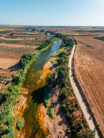 Aerial view of a river winding through agricultural fields and olive groves in Andalusia Spain. Aerial view of a river winding through agricultural fields and olive groves in Andalusia Spain.