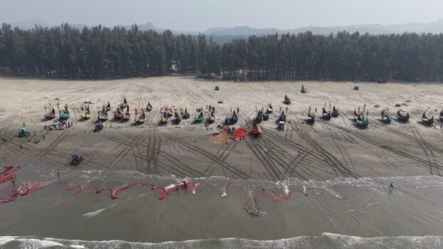 Aerial view of traditional fishing boats on the beach in Bangladesh. Aerial view of traditional fishing boats on the beach in Bangladesh.