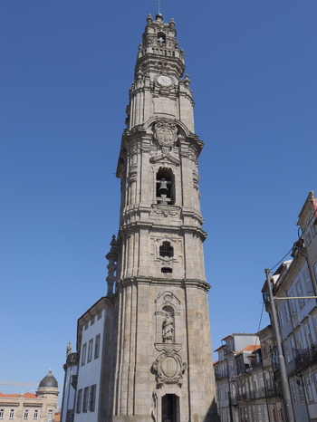 View of Clerigos Tower a historic baroque bell tower with intricate stone carvings and a clock face set against a clear blue sky in the city center Porto Porto District Portugal. View of Clerigos Tower a historic baroque bell tower with intricate stone carvings and a clock face set against a clear blue sky in the city center Porto Porto District Portugal.