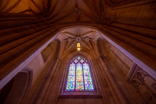 Washington District of Columbia United States 06 May 2025 View of the stained glass window and vaulted stone ceiling inside the Washington National Cathedral.