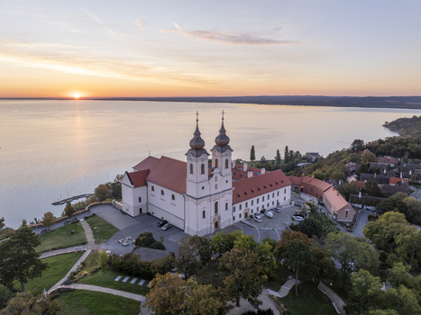 Aerial view of Tihany Abbey with its iconic twin towers overlooking Lake Balaton at sunset in Tihany Hungary. Aerial view of Tihany Abbey with its iconic twin towers overlooking Lake Balaton at sunset in Tihany Hungary.