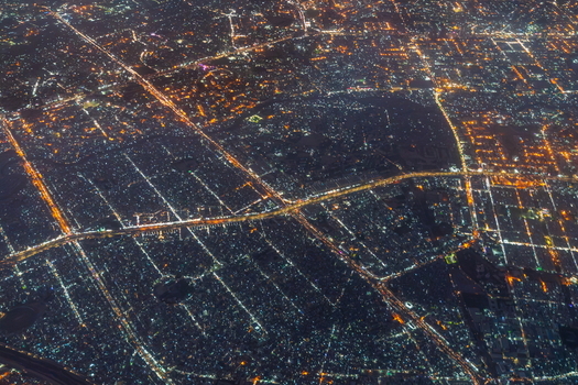 Aerial view of the sprawling urban landscape of Karachi at night with dense grids of illuminated streets and highways stretching across the city Karachi Sindh Pakistan.