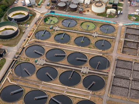 Aerial view of the water treatment plant featuring numerous circular sedimentation tanks and industrial infrastructure in Broughton England United Kingdom. Aerial view of the water treatment plant featuring numerous circular sedimentation tanks and industrial infrastructure in Broughton England United Kingdom.