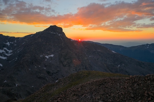 Aerial view of Mount of the Holy Cross in the Sawatch Range of the Rocky Mountains at sunrise with golden light illuminating rugged peaks in Vail Colorado United States. Aerial view of Mount of the Holy Cross in the Sawatch Range of the Rocky Mountains at sunrise with golden light illuminating rugged peaks in Vail Colorado United States.