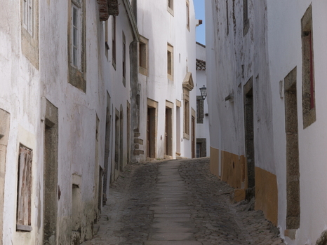 View of the narrow cobblestone street lined with traditional white washed houses in the historic village of Marvao Portalegre District Portugal. View of the narrow cobblestone street lined with traditional white washed houses in the historic village of Marvao Portalegre District Portugal.