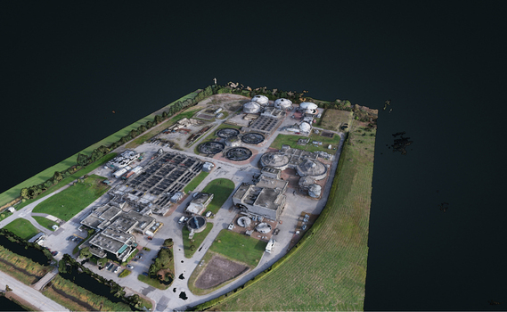 Aerial view of a wastewater treatment plant with circular sedimentation tanks and industrial buildings surrounded by green space and water in Richmond British Columbia CA. Aerial view of a wastewater treatment plant with circular sedimentation tanks and industrial buildings surrounded by green space and water in Richmond British Columbia CA.