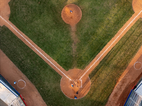 Aerial view of a baseball field with players on the diamond featuring the pitcher s mound and home plate in Santo Domingo Distrito Nacional Dominican Republic.