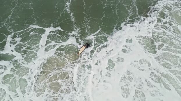 Aerial view of a surfer in the ocean United States.