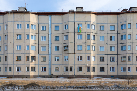 View of a multi story residential apartment building with panel facade and many windows in Severobaykalsk Buryatia Russia.
