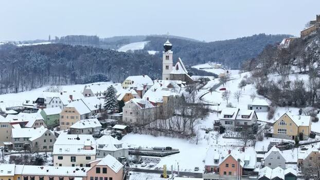 Aerial view of Riegersburg village and church in winter Austria.