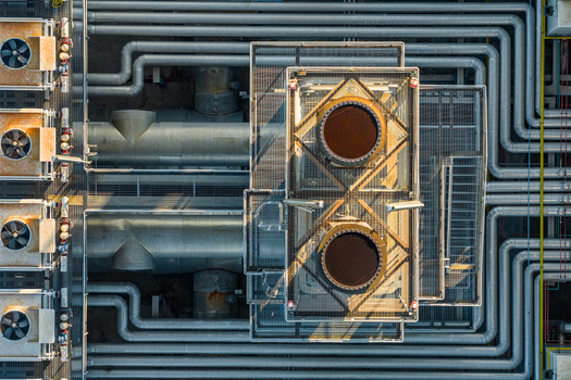 Aerial view of industrial plant with complex piping systems cooling fans and metallic structures in Rome Lazio Italy.