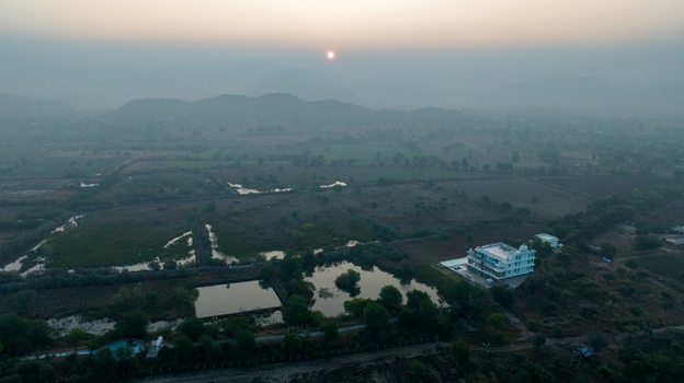 Aerial view of a white building situated near small water bodies and fields in the rural landscape of Jodhpur Rajasthan India. Aerial view of a white building situated near small water bodies and fields in the rural landscape of Jodhpur Rajasthan India.
