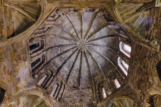 Plasencia Spain 03 December 2025 View of the intricate stone ribbed vaulting of the Catedral Nueva de Plasencia with sunlight filtering through narrow windows. Plasencia Spain 03 December 2025 View of the intricate stone ribbed vaulting of the Catedral Nueva de Plasencia with sunlight filtering through narrow windows.