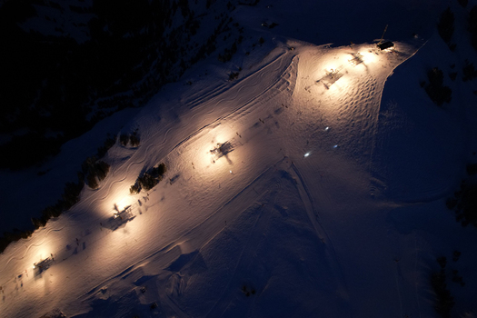 Aerial view of Les Crosets ski resort at night with illuminated slopes and chairlift stations in Val d Illiez Valais Switzerland. Aerial view of Les Crosets ski resort at night with illuminated slopes and chairlift stations in Val d Illiez Valais Switzerland.