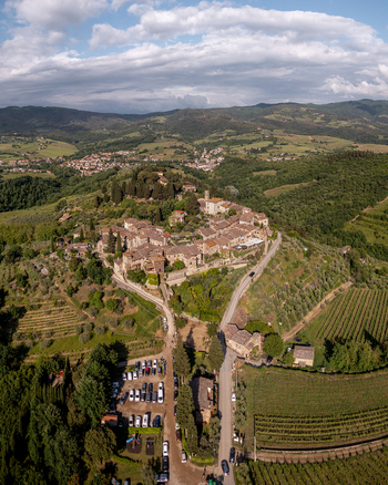 Aerial view of the historic village of Montefioralle surrounded by lush vineyards rolling hills and stone architecture in Montefioralle Tuscany Italy. Aerial view of the historic village of Montefioralle surrounded by lush vineyards rolling hills and stone architecture in Montefioralle Tuscany Italy.