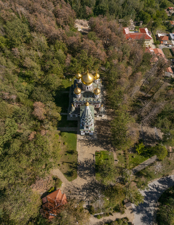 Aerial view of the Shipka Memorial Church with its golden domes nestled among the dense autumn forest in Shipka Stara Zagora Bulgaria. Aerial view of the Shipka Memorial Church with its golden domes nestled among the dense autumn forest in Shipka Stara Zagora Bulgaria.
