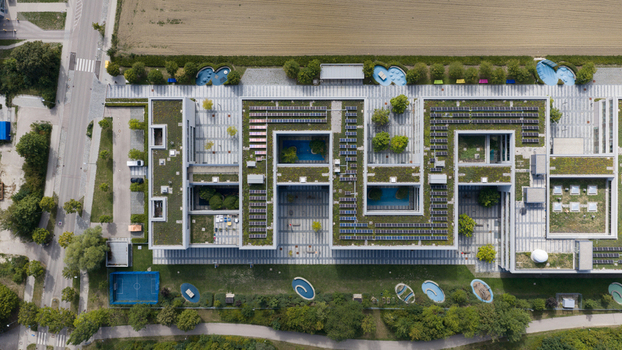 Unterfohring Germany 12 September 2026 Aerial view of the Allianz Commercial office building with green roofs solar panels and courtyards set within landscaped grounds.