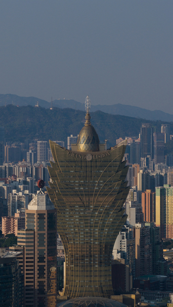 Macao 18 February 2026 Aerial view of the Grand Lisboa hotel a distinctive lotus shaped skyscraper rising above the dense urban skyline of Macau under a clear sky. Macao 18 February 2026 Aerial view of the Grand Lisboa hotel a distinctive lotus shaped skyscraper rising above the dense urban skyline of Macau under a clear sky.