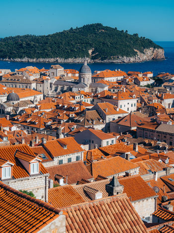 View of the historic terracotta rooftops and stone architecture of Dubrovnik Old Town with Lokrum Island in the background Dubrovnik Dubrovnik Neretva Croatia. View of the historic terracotta rooftops and stone architecture of Dubrovnik Old Town with Lokrum Island in the background Dubrovnik Dubrovnik Neretva Croatia.