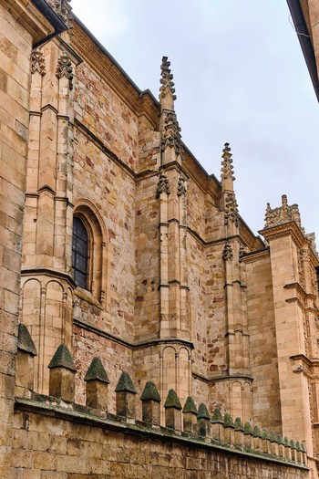 Salamanca Spain 29 November 2025 View of the ornate Gothic facade and stone spires of the University of Salamanca under a cloudy sky.