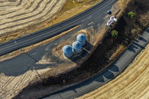 Aerial view of three grain silos on a hillside surrounded by agricultural fields in the Palouse region Palouse Washington United States. Aerial view of three grain silos on a hillside surrounded by agricultural fields in the Palouse region Palouse Washington United States.