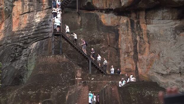 View of tourists climbing the staircase of Sigiriya Rock Sri Lanka.