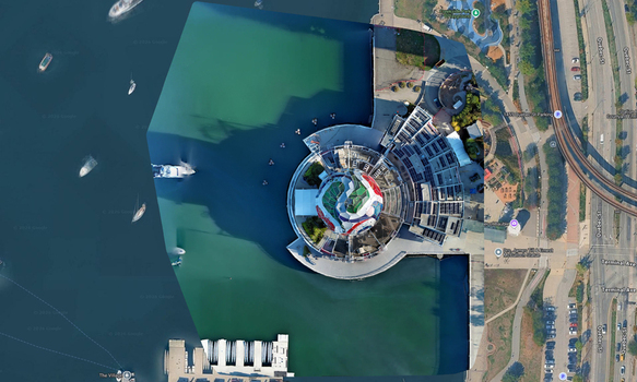 Aerial view of Science World a geodesic dome structure situated on the waterfront with surrounding parkland and urban infrastructure in Vancouver British Columbia Canada. Aerial view of Science World a geodesic dome structure situated on the waterfront with surrounding parkland and urban infrastructure in Vancouver British Columbia Canada.