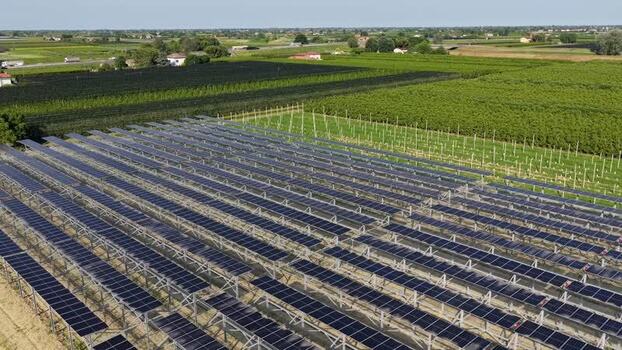 Aerial view of solar panels in a rural field in Italy.