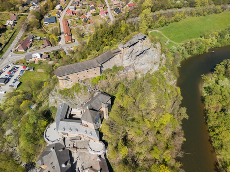Aerial view of Orava Castle perched on a high rock cliff overlooking the river and surrounding green forest in Dolny Kubin Zilinsky kraj Slovakia. Aerial view of Orava Castle perched on a high rock cliff overlooking the river and surrounding green forest in Dolny Kubin Zilinsky kraj Slovakia.