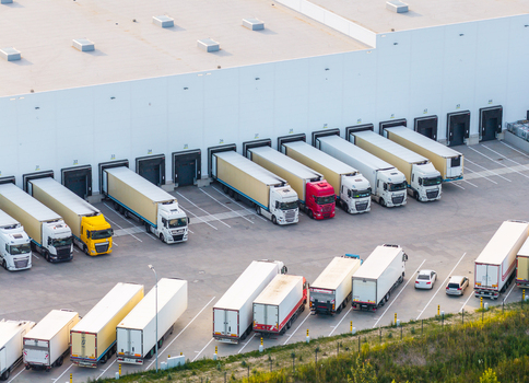 Aerial view of the Gdansk Kowale Distribution Centre with numerous semi trucks and trailers parked at loading docks and in the yard in Kowale Wojewodztwo pomorskie Poland. Aerial view of the Gdansk Kowale Distribution Centre with numerous semi trucks and trailers parked at loading docks and in the yard in Kowale Wojewodztwo pomorskie Poland.