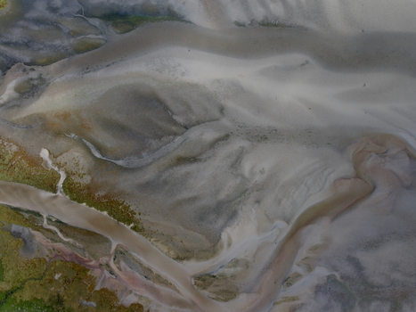 Aerial view of abstract tidal patterns at Culbin Sands with intricate sand formations and water channels in Nairn Scotland United Kingdom. Aerial view of abstract tidal patterns at Culbin Sands with intricate sand formations and water channels in Nairn Scotland United Kingdom.