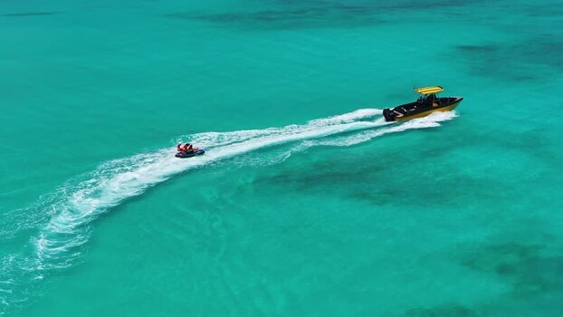 Aerial view of a boat towing an inflatable tube Maldives. Aerial view of a boat towing an inflatable tube Maldives.