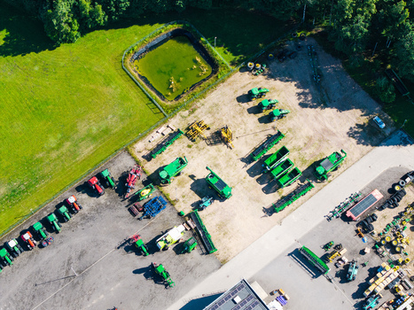 Kekava Kekava Municipality Latvia 05 July 2026 Aerial view of an agricultural machinery dealership with rows of green tractors and farm equipment parked on a gravel lot. Kekava Kekava Municipality Latvia 05 July 2026 Aerial view of an agricultural machinery dealership with rows of green tractors and farm equipment parked on a gravel lot.