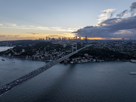 Aerial view of Fatih Sultan Mehmet Bridge spanning the Bosphorus at sunset with the city skyline in the background Beykoz Istanbul Turkey. Aerial view of Fatih Sultan Mehmet Bridge spanning the Bosphorus at sunset with the city skyline in the background Beykoz Istanbul Turkey.