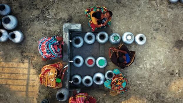 Aerial view of people collecting water from a tap Bangladesh.