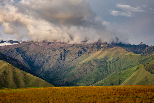View of the Sacred Valley at sunset with dramatic storm clouds gathering over the rugged Andes mountain range in Urubamba Province Cusco Peru. View of the Sacred Valley at sunset with dramatic storm clouds gathering over the rugged Andes mountain range in Urubamba Province Cusco Peru.